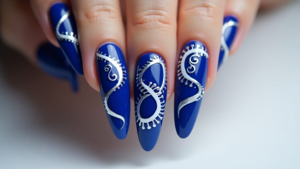 Artsy cobalt blue nails with bold patterns.