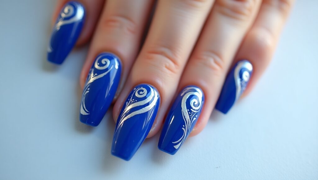 Artsy cobalt blue nails with bold patterns.