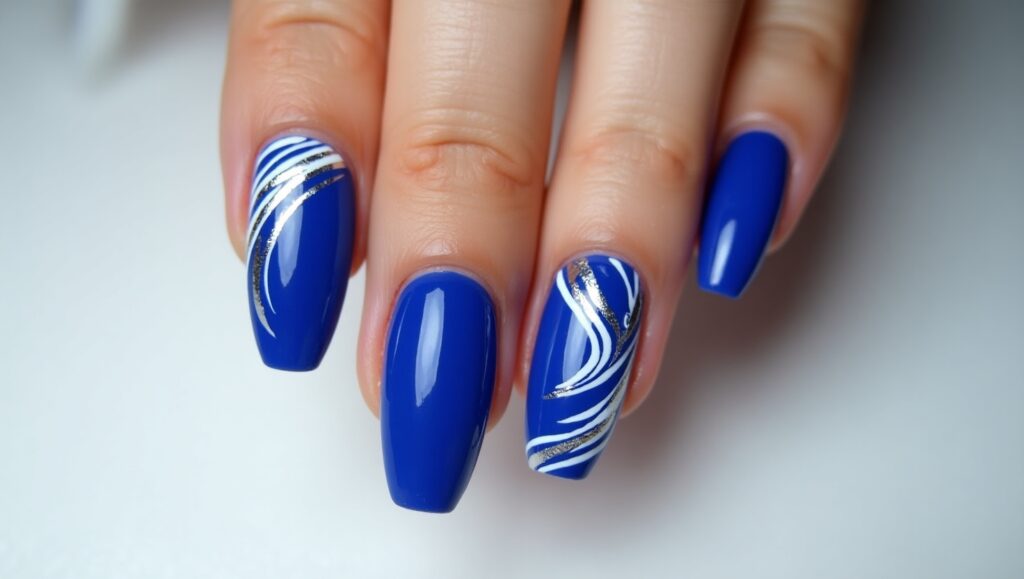 Artsy cobalt blue nails with bold patterns.