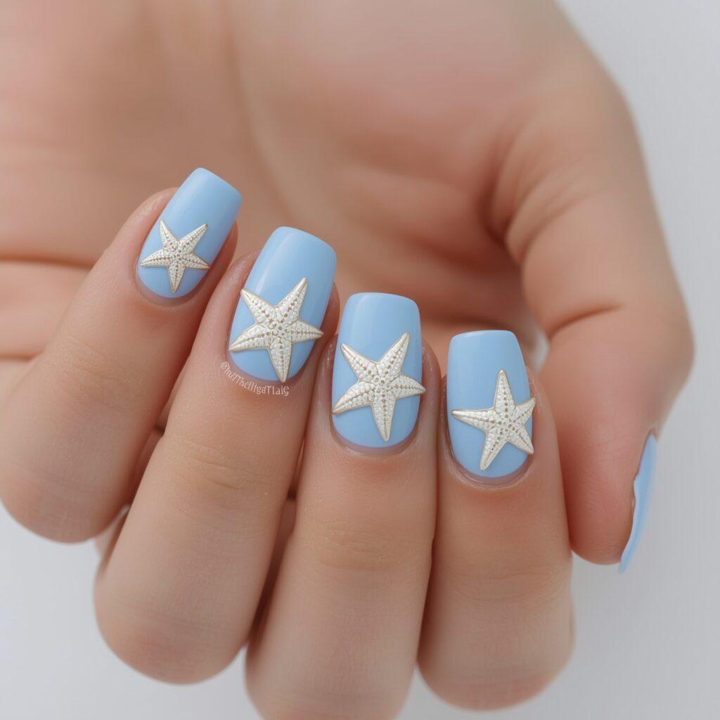 Light blue French manicure topped with starfish details.
